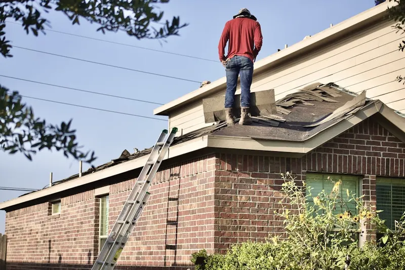 Professional roofer working on a residential roof in Vincennes